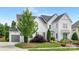 Beautiful two-story home with a lush lawn, an attached garage, and a well-manicured landscape at 2026 Thatcher Way, Fort Mill, SC 29715