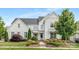 Charming two-story home with a beautifully landscaped front yard and attractive modern farmhouse design at 2026 Thatcher Way, Fort Mill, SC 29715