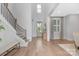 Bright foyer features hardwood floors, staircase with iron railing, and an abundance of natural light at 2026 Thatcher Way, Fort Mill, SC 29715