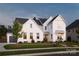 Charming two-story home with a classic design, featuring a well-manicured lawn and mature trees at 2026 Thatcher Way, Fort Mill, SC 29715