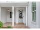 Inviting covered front porch with brick flooring, pendant lights, and columns that create a warm welcome at 2026 Thatcher Way, Fort Mill, SC 29715