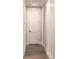 Hallway features white trim, wainscoting, wood-look flooring, and a white door with a black handle at 2026 Thatcher Way, Fort Mill, SC 29715