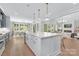 Gourmet kitchen with an island, stainless appliances, and an open view to the dining and living spaces at 2026 Thatcher Way, Fort Mill, SC 29715