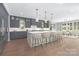 Bright kitchen features a large island with bar seating and stylish gray cabinetry at 2026 Thatcher Way, Fort Mill, SC 29715