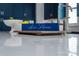 Bright kitchen featuring blue cabinets, white countertop, and decor reading 