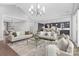 Spacious living room featuring modern lighting, neutral decor, and an open layout with kitchen and dining views at 2026 Thatcher Way, Fort Mill, SC 29715