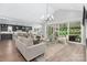 Bright living room with vaulted ceiling and an open layout connects to the kitchen and patio at 2026 Thatcher Way, Fort Mill, SC 29715