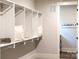 Walk-in closet featuring open shelving, ample storage space, and access to the laundry area at 2026 Thatcher Way, Fort Mill, SC 29715