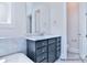 Bathroom vanity with marble countertop, chrome faucet, mirror and gray cabinet at 20392 Queens St, Cornelius, NC 28031