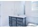 Bathroom vanity with marble countertop, chrome faucet, mirror and gray cabinet at 20392 Queens St, Cornelius, NC 28031