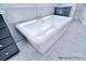 White soaking tub with chrome faucet and marble tile backsplash at 20392 Queens St, Cornelius, NC 28031