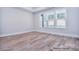 Bedroom with wood flooring and large windows at 20392 Queens St, Cornelius, NC 28031