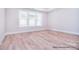 Bright and airy bedroom featuring hardwood floors, ample natural light, and neutral wall colors at 20392 Queens St, Cornelius, NC 28031