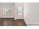 Bright entryway with wood floors and a decorative front door at 20392 Queens St, Cornelius, NC 28031