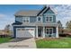 Charming two-story home with blue siding, a white garage door, and well-maintained lawn at 20392 Queens St, Cornelius, NC 28031