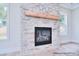 Close-up of a stylish fireplace with a stone surround and a wooden mantle at 20392 Queens St, Cornelius, NC 28031