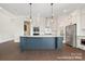Modern kitchen featuring a large island with seating, stainless steel appliances, and ample cabinet space at 20392 Queens St, Cornelius, NC 28031