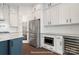 Well-equipped kitchen boasting stainless steel appliances and white cabinetry, plus a beverage cooler at 20392 Queens St, Cornelius, NC 28031