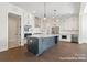 Bright kitchen featuring a large island with seating, stainless steel appliances, and ample cabinet space at 20392 Queens St, Cornelius, NC 28031