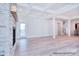 Bright living room featuring coffered ceilings, a fireplace, hardwood floors, and access to an outdoor space at 20392 Queens St, Cornelius, NC 28031
