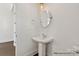 Charming powder room featuring pedestal sink and modern fixtures at 20392 Queens St, Cornelius, NC 28031