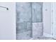 Tiled shower with glass door, chrome fixtures and gray stone tile at 20392 Queens St, Cornelius, NC 28031