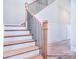 Classic staircase design with wood steps and white risers and stringers at 20392 Queens St, Cornelius, NC 28031