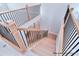 Elegant staircase with wooden handrail and black iron balusters at 20392 Queens St, Cornelius, NC 28031
