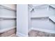 Walk-in closet with wood flooring and built-in shelves at 20392 Queens St, Cornelius, NC 28031