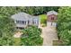Aerial view of home featuring mature trees, long driveway, detached garage, and well-maintained landscaping at 220 Glenville Dr, Fort Mill, SC 29715