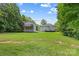 Spacious backyard with lush greenery, featuring a deck and covered deck space, ideal for recreation at 220 Glenville Dr, Fort Mill, SC 29715