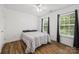 Cozy bedroom has wood floors, a ceiling fan, and two windows at 220 Glenville Dr, Fort Mill, SC 29715