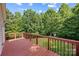 Spacious wooden deck overlooks a lush, green backyard, perfect for outdoor relaxation and entertaining at 220 Glenville Dr, Fort Mill, SC 29715
