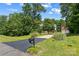 Long asphalt driveway leading to a lovely home nestled among mature trees, providing privacy at 220 Glenville Dr, Fort Mill, SC 29715