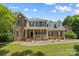 Charming two-story brick home with a welcoming front porch and well-manicured lawn at 220 Glenville Dr, Fort Mill, SC 29715