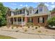 Traditional two-story home with brick facade, black shutters, and landscaped front yard at 220 Glenville Dr, Fort Mill, SC 29715