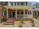 Inviting brick front porch with white railings, perfect for relaxing and enjoying the outdoors at 220 Glenville Dr, Fort Mill, SC 29715