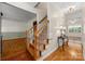 Beautiful hallway with hardwood floors, staircase, and a view to adjacent living spaces at 220 Glenville Dr, Fort Mill, SC 29715