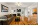 Open living room with a fireplace, hardwood floors, and seamless transition to the kitchen at 220 Glenville Dr, Fort Mill, SC 29715