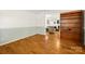 Bright living room with hardwood floors, an adjacent room, and a built-in bookshelf at 220 Glenville Dr, Fort Mill, SC 29715