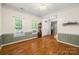 Spacious living room with wainscoting, hardwood floors and an abundance of natural light at 220 Glenville Dr, Fort Mill, SC 29715