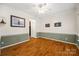 Elegant living room with hardwood floors, wainscoting, and ample natural light at 220 Glenville Dr, Fort Mill, SC 29715