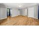This main bedroom is spacious with neutral walls, beautiful hardwood floors, two windows, and a ceiling fan at 220 Glenville Dr, Fort Mill, SC 29715