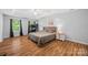 Spacious main bedroom features a tray ceiling, wood floors and abundant natural light at 220 Glenville Dr, Fort Mill, SC 29715