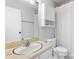 Clean bathroom with a vanity, toilet, and shower with white fixtures and ample lighting at 2638 Park Rd # H, Charlotte, NC 28209