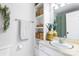 Well-lit bathroom featuring a vanity with built in shelving, a mirror, and a shower curtain at 2638 Park Rd # H, Charlotte, NC 28209