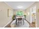 Cozy dining room featuring a wooden table, neutral walls, and an open view to the outdoors at 2638 Park Rd # H, Charlotte, NC 28209