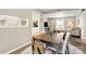 Cozy dining area with a wooden table, neutral walls, and open access to both the kitchen and living room at 2638 Park Rd # H, Charlotte, NC 28209