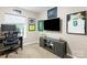 Functional home office setup with desk, storage cabinet, natural lighting, and sports memorabilia at 2638 Park Rd # H, Charlotte, NC 28209