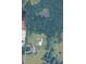 An aerial view of a sprawling property featuring lush greenery, a serene pond, and multiple buildings at 269 Johnson Dairy Rd, Mooresville, NC 28115